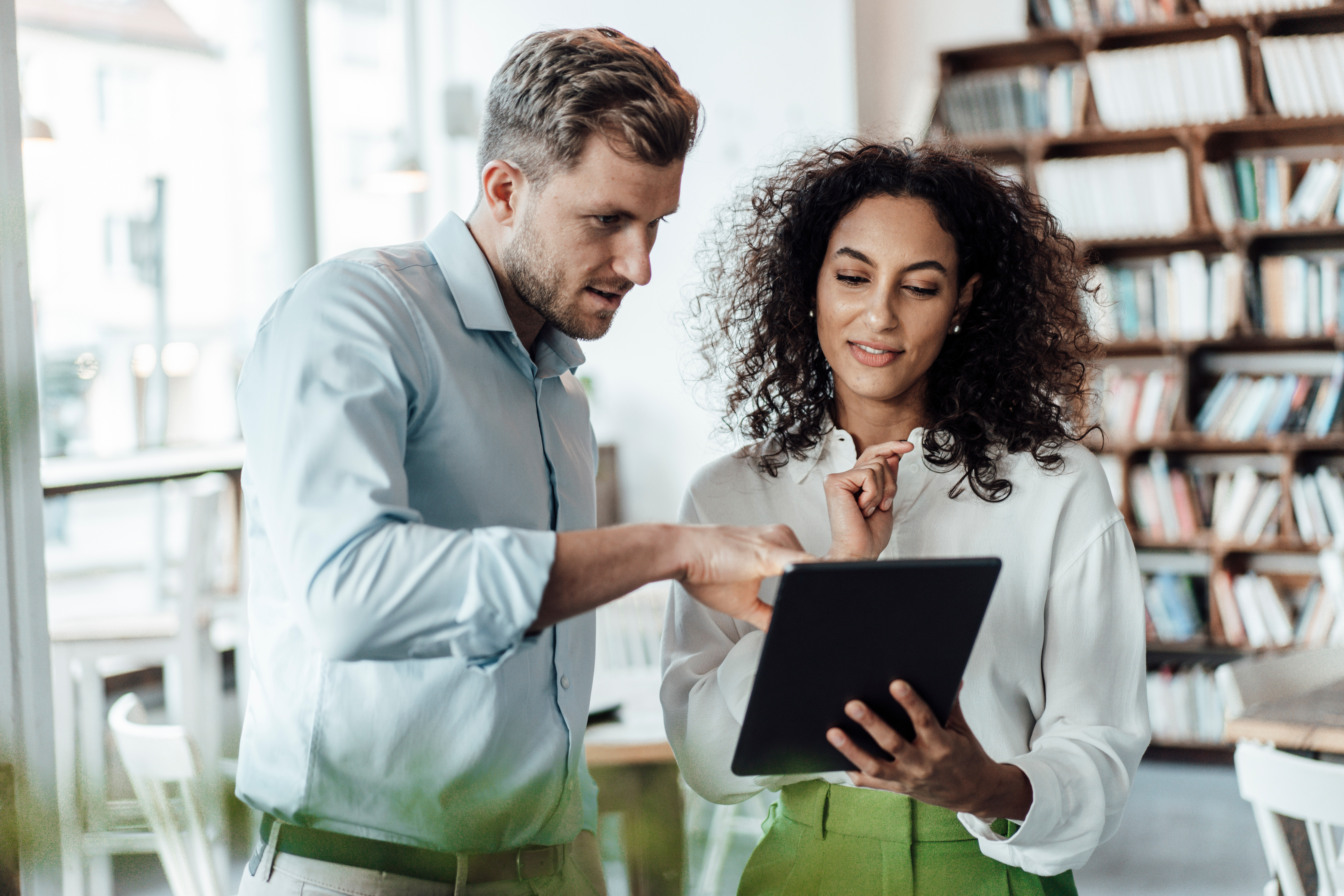 Two employees looking at a tablet.