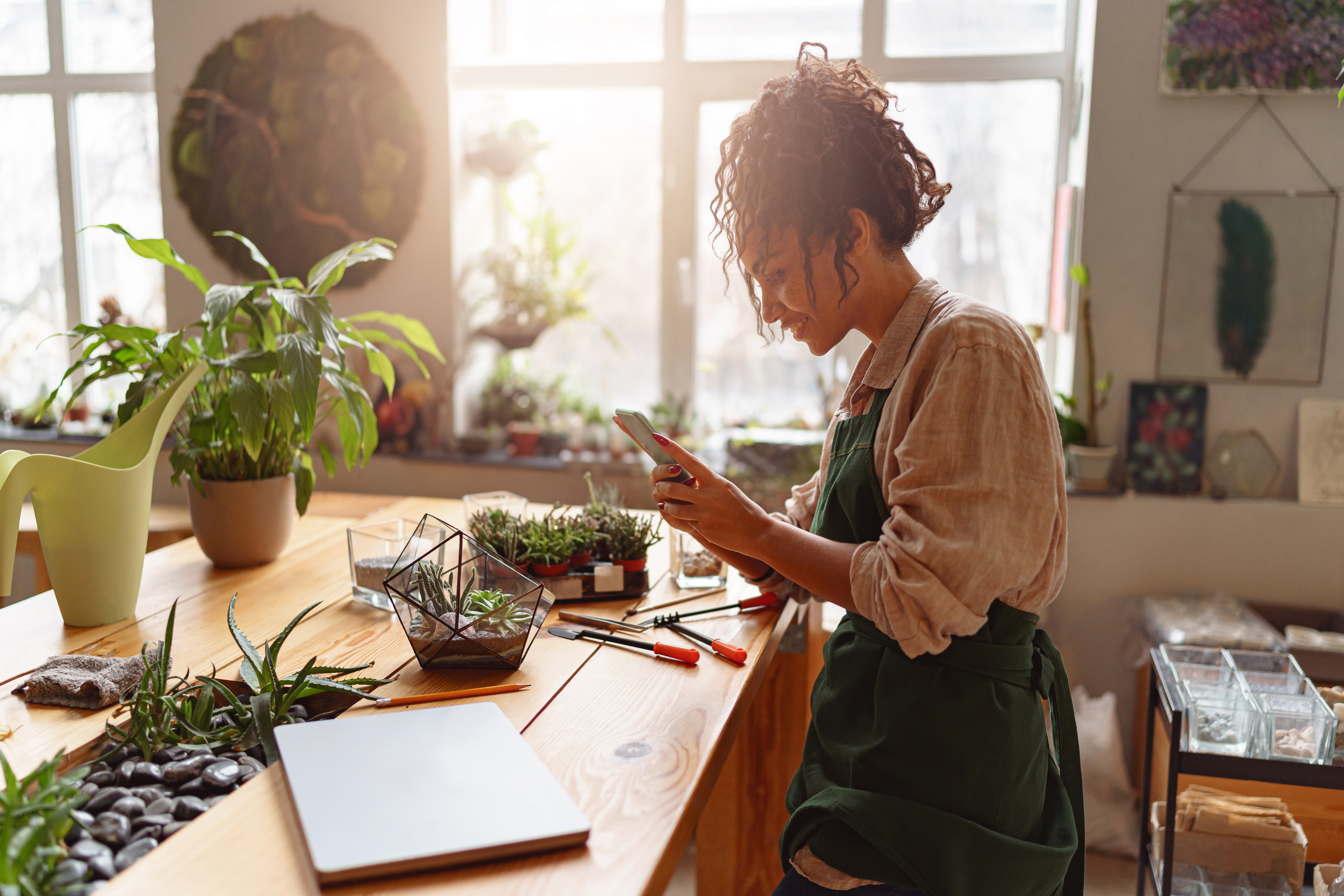 A female entrepreneur photographing her plants.