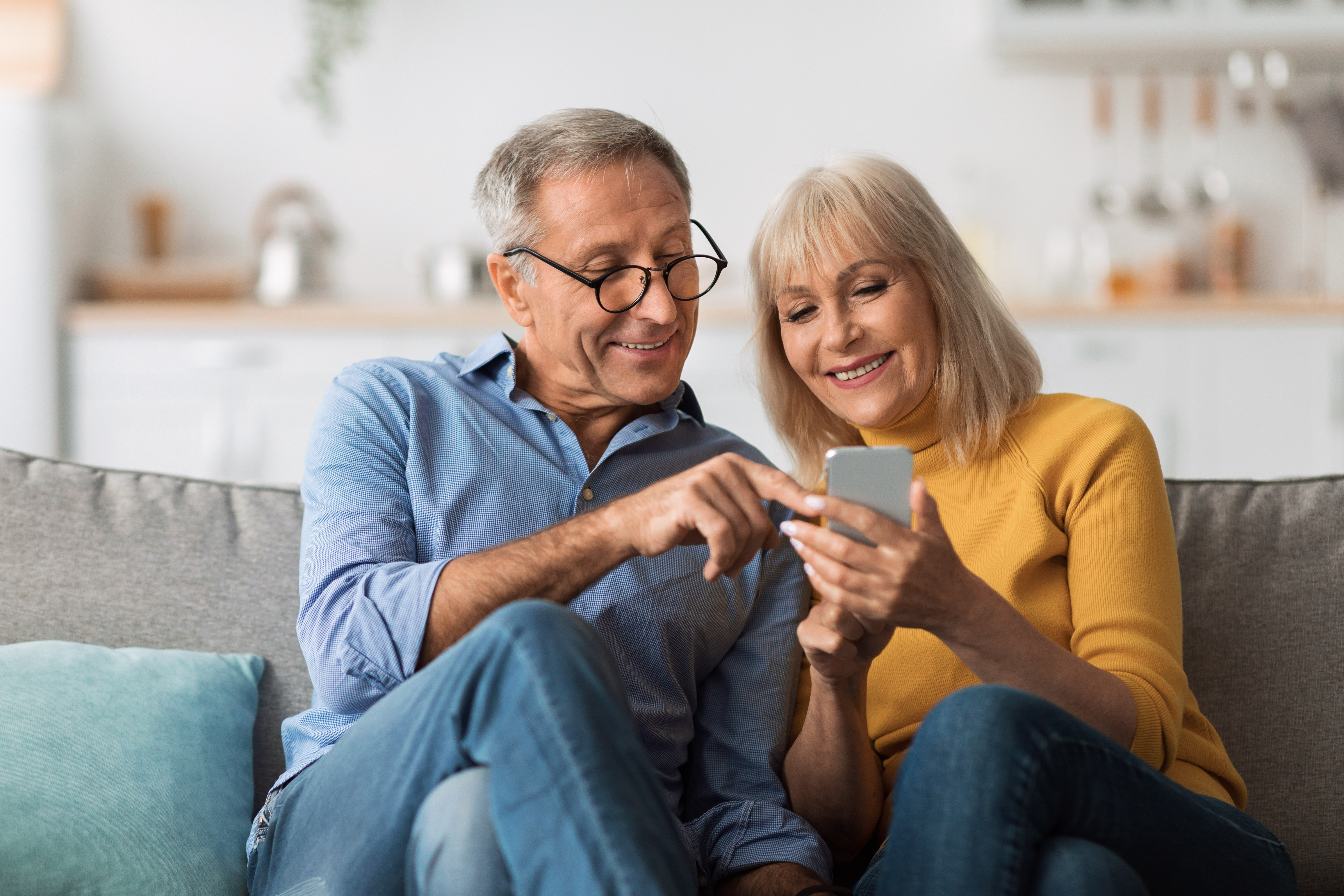 An older couple looking at a smartphone.